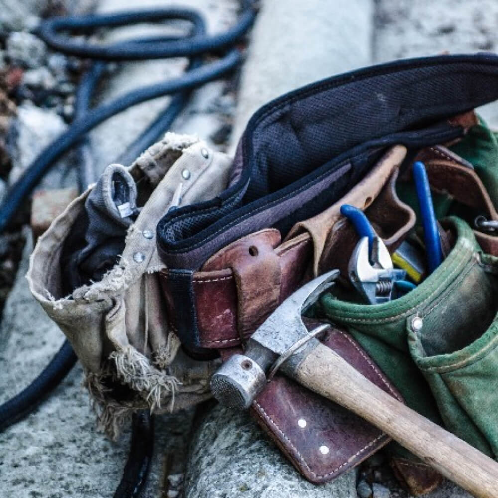 A diverse assortment of tools scattered on the ground, showcasing a range of equipment for various tasks.